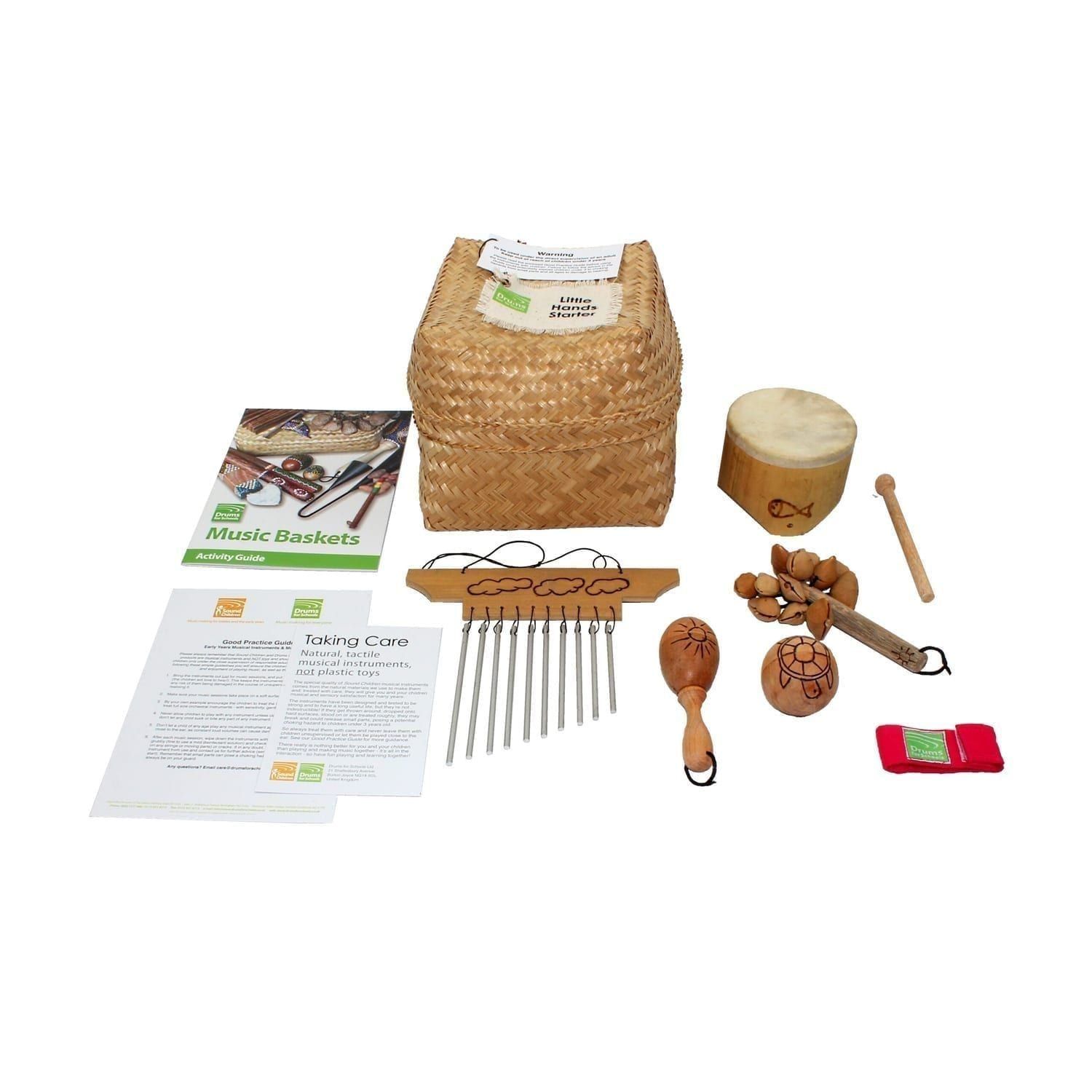 Little Hands Starter Basket - 5 Instruments, with the contents laid out flat outside of the basket, include one Bamboo Mini Drum, one  Ball Shaker - 5cm, Early Years - Early Years, one Wind Chime - Early Years, one Kenari Shaker - Early Years, one Music Bracelet - XS, one Egg on Stick - Small - 5cm, Early Years.
